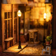The glowing wrought-iron street lamp in The Sunset Lane