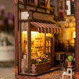 A glowing timber storefront with striped awning in The Sunset Lane