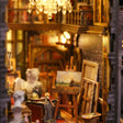 Lit interior of The Painter's Atelier with easels, oil paintings and a plaster bust