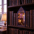 The Arcane Tower book nook slotted on a bookshelf between leather books at dusk