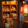 Macro of the lit izakaya bar counter with tiny sake bottles