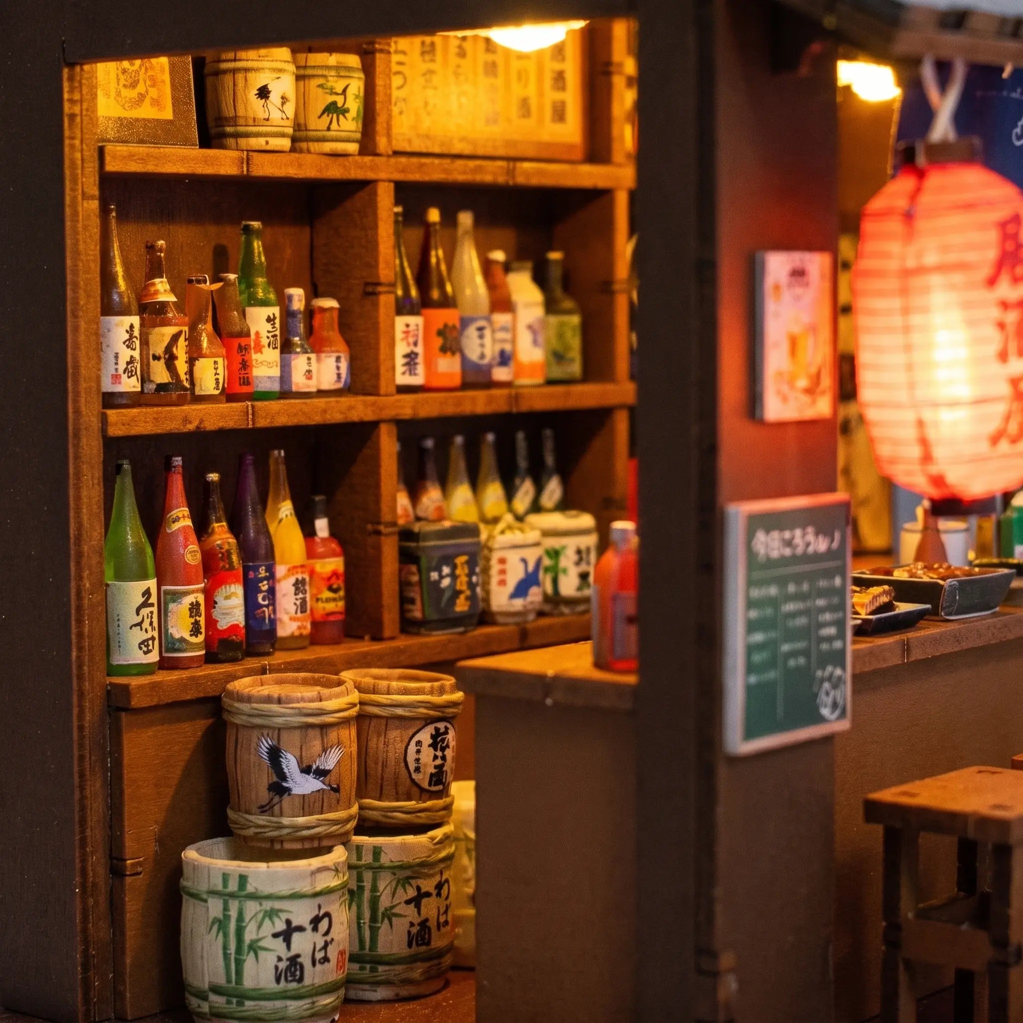 Macro of the lit izakaya bar counter with tiny sake bottles