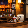 Close-up of the lucky cat figurine and sake barrel