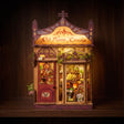 The Serenade book nook glowing on a dark walnut shelf at night