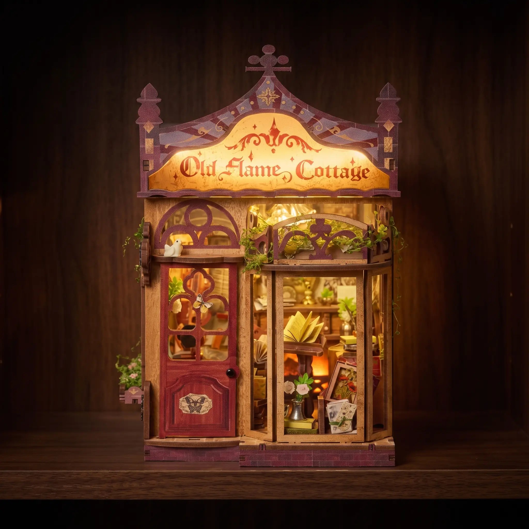 The Serenade book nook glowing on a dark walnut shelf at night