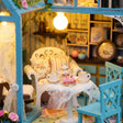 Close up of the lace tea table with teapot, teacups and pink cake