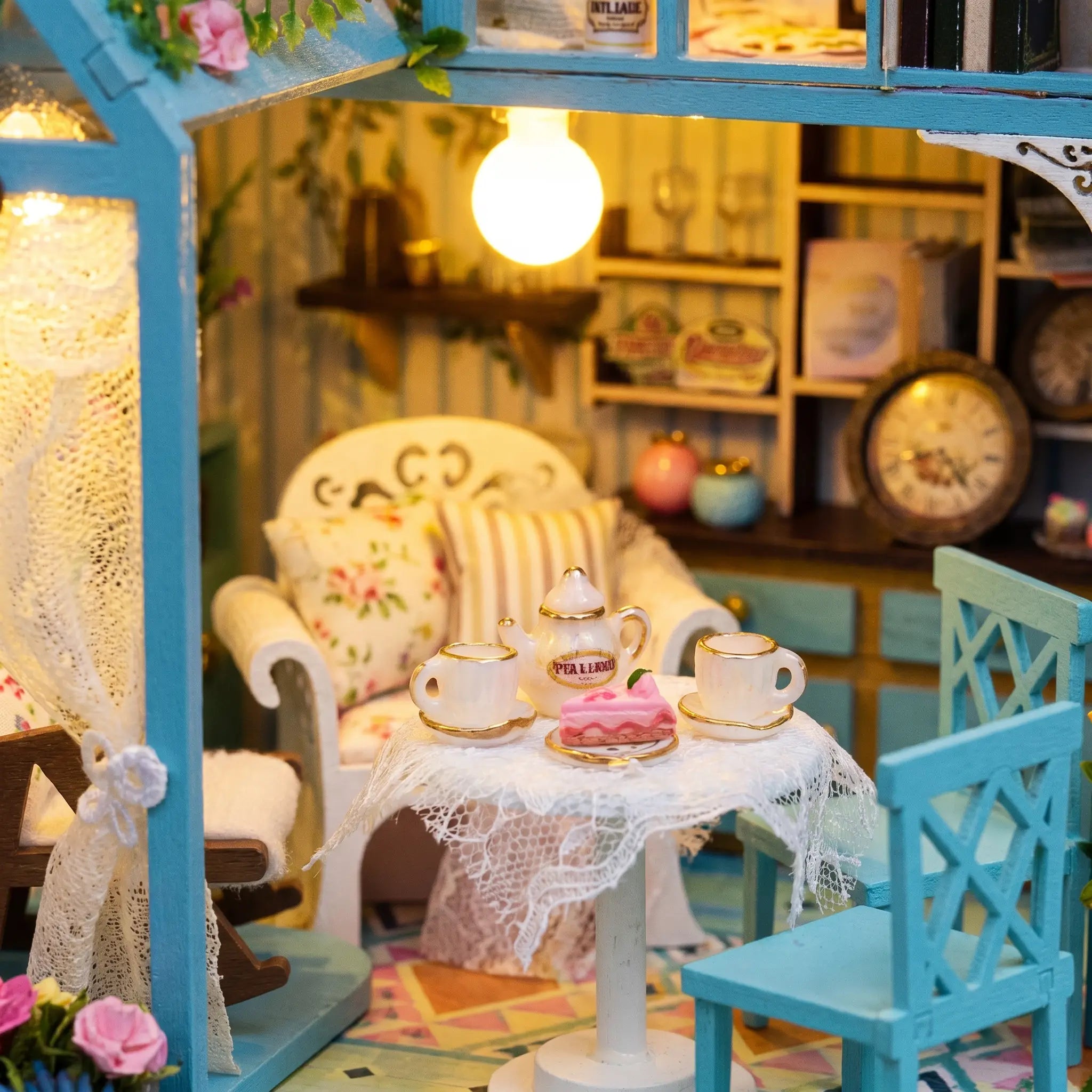 Close up of the lace tea table with teapot, teacups and pink cake