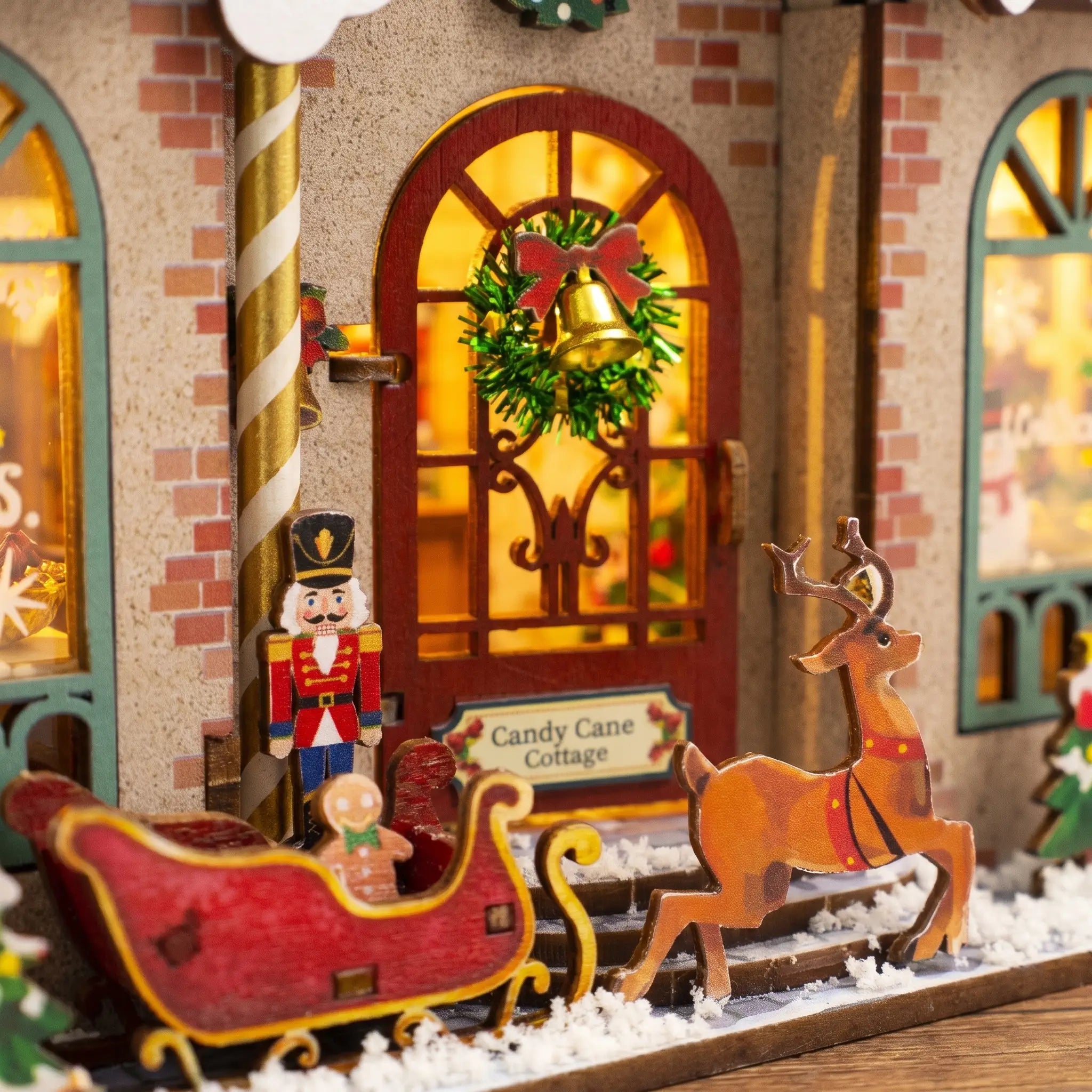 Front door detail of The Candy Cane Cottage with nutcracker, sleigh and reindeer