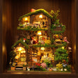 The Elderwood Treehouse glowing on a dark walnut shelf at night