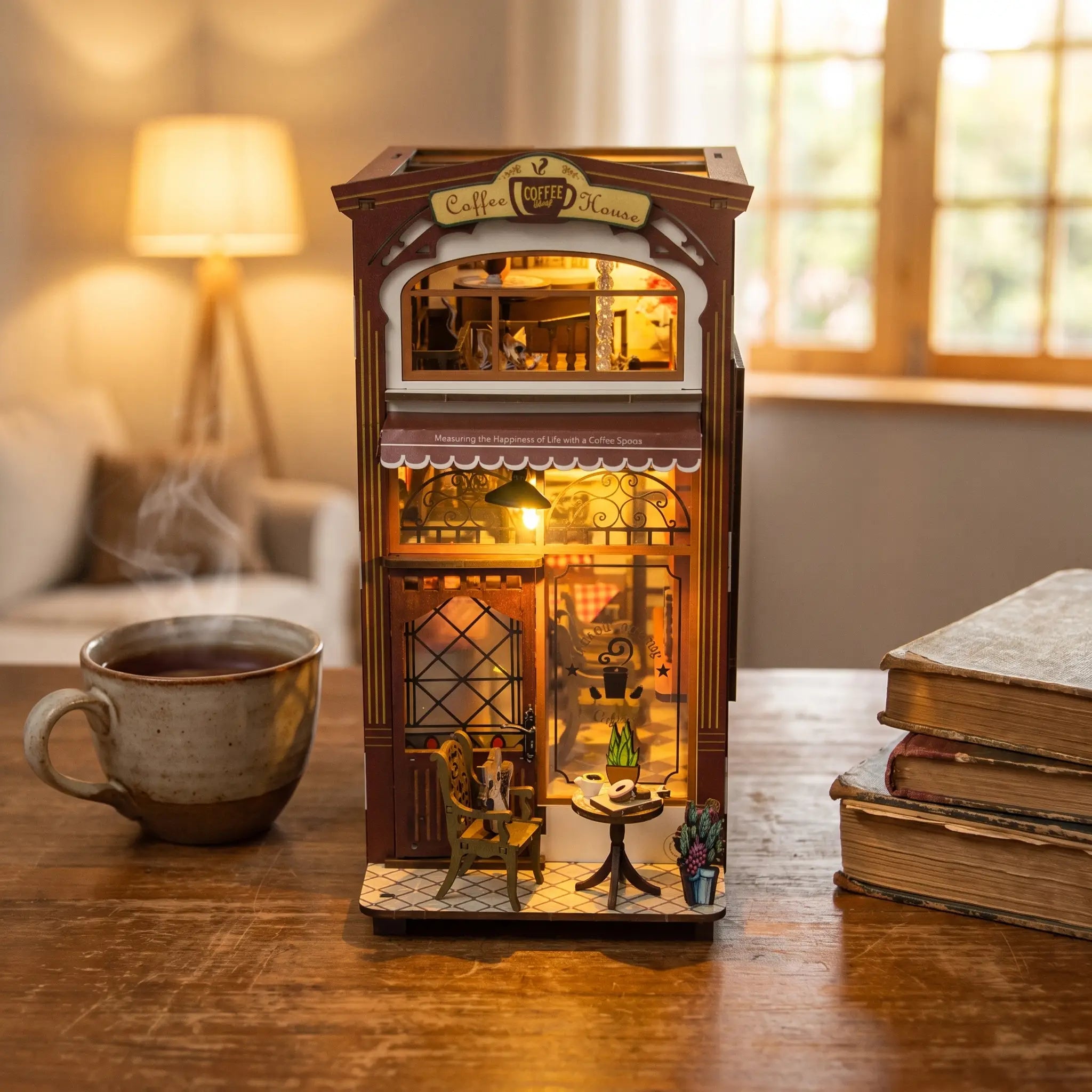 The Coffee House on a wooden desk at dusk beside a mug of tea