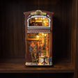 The Coffee House book nook glowing on a dark walnut shelf at night