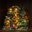 The Winterwood Treehouse glowing on a dark walnut shelf at night, snow-dusted roofs