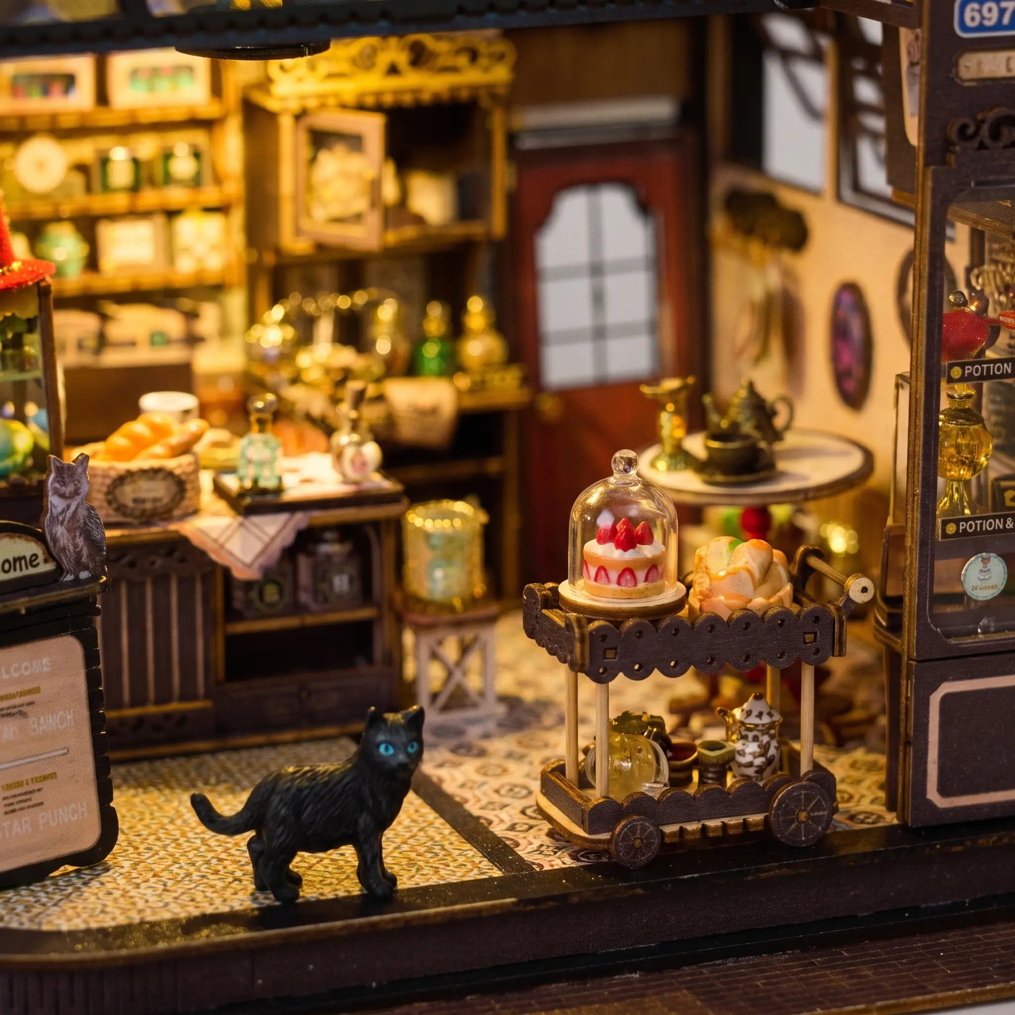 Close up of the dessert cart with strawberry cake and the black cat