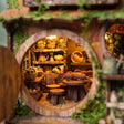Close up of the pantry shelves stacked with baskets, jugs and bread inside The Mossy Hollow