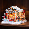 The Christmas Eve Lodge glowing on a dark walnut shelf at night