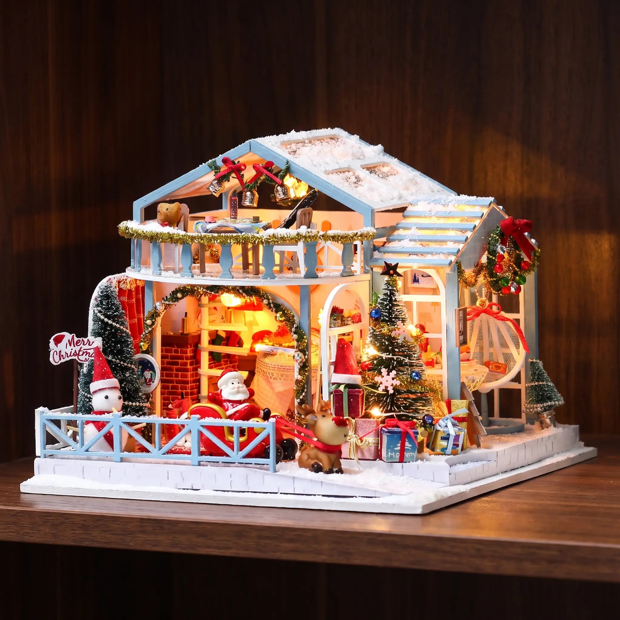The Christmas Eve Lodge glowing on a dark walnut shelf at night