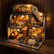 The Grand Cafe kit glowing on a dark walnut shelf at night