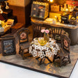 Close up of the lace covered table with gold teapot and coffee cups