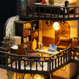 Close up of the mezzanine with bookshelves and a tiny laptop