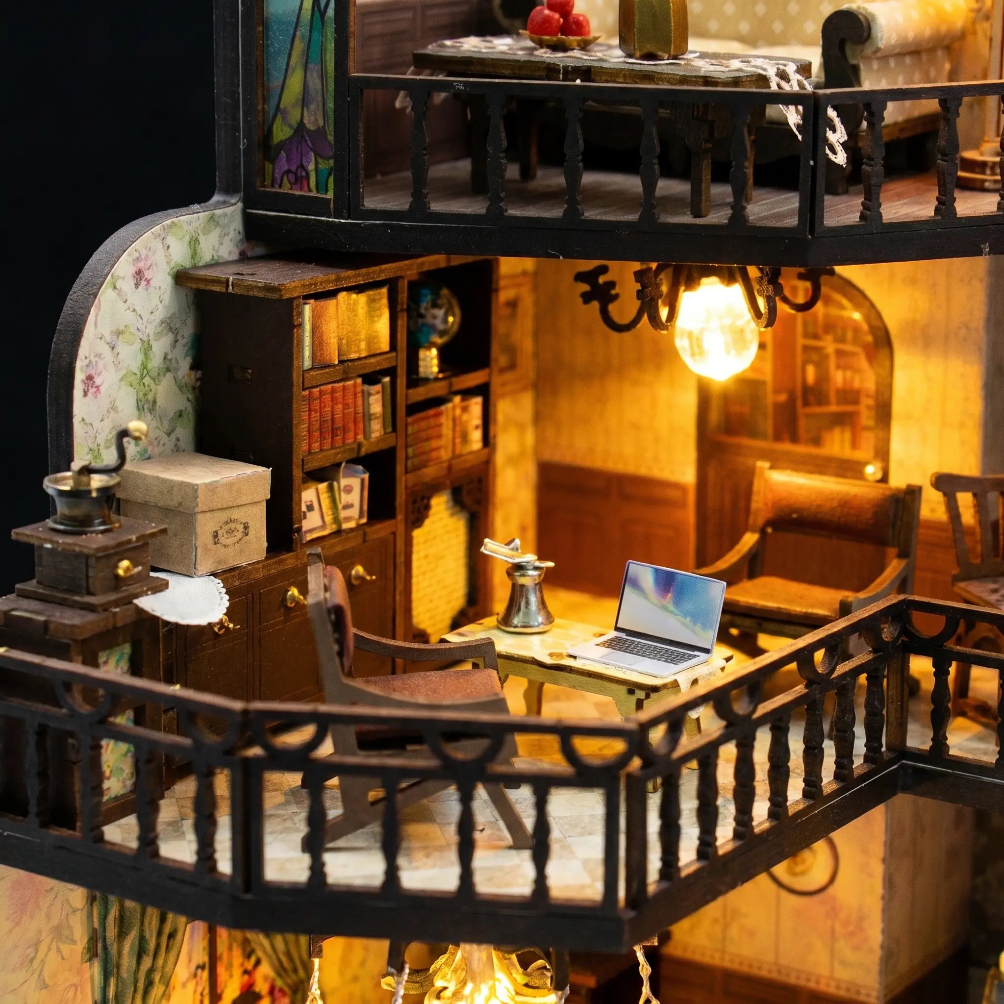Close up of the mezzanine with bookshelves and a tiny laptop