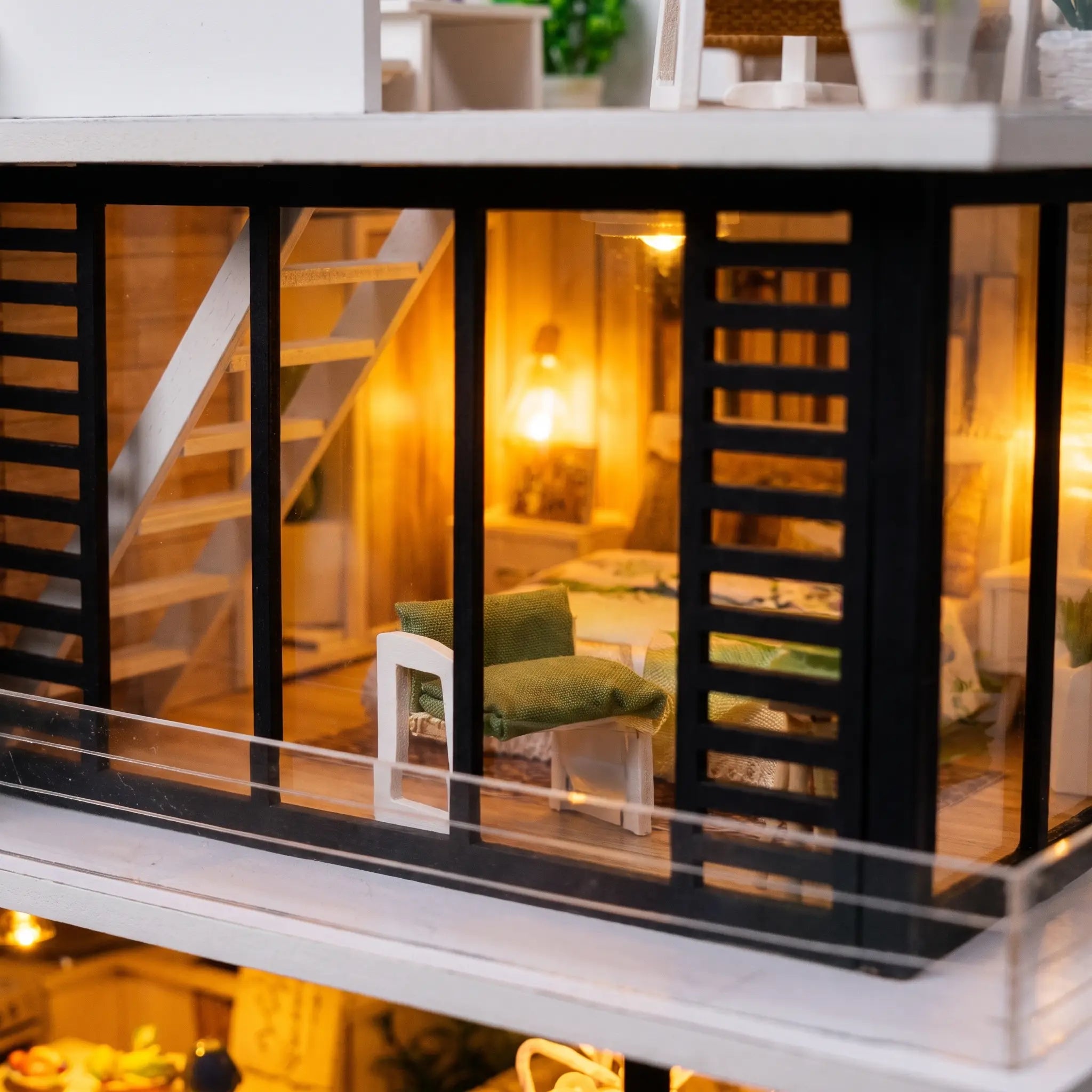 Close up of the glass walled bedroom with warm bedside lamp inside The Glass Villa