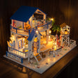 The Seaside Villa kit glowing on a dark walnut shelf at night