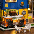 Close up of the orange camper van food truck with menu boards and striped awning