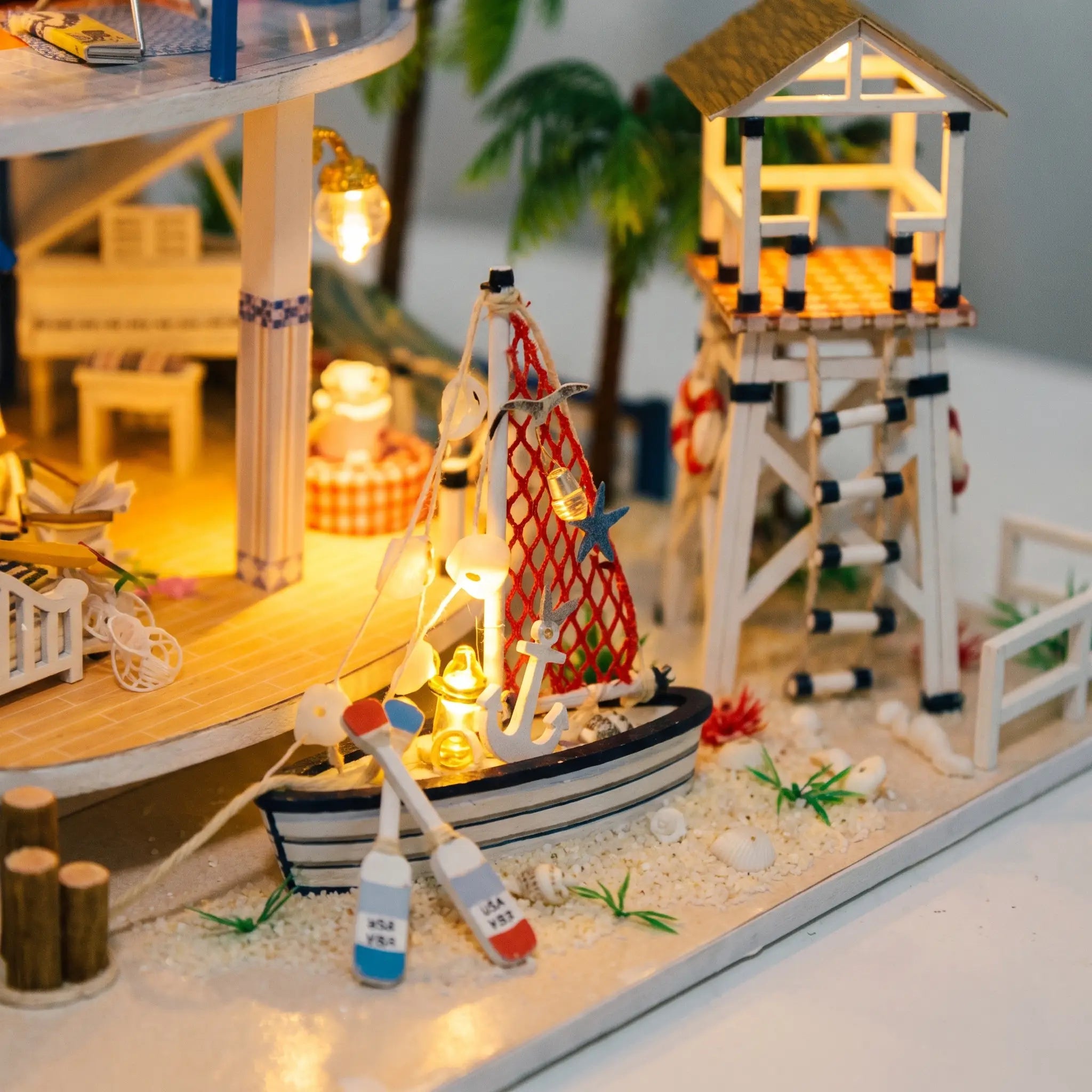 Close up of the sailboat and lifeguard tower on the sandy shore