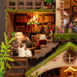 Close up of the library with beaded chandelier, plaid armchair and white cat