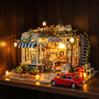 The Pet Club miniature kit glowing on a dark walnut shelf at night