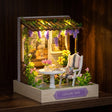 The Wisteria Patio glowing on a dark walnut shelf at night