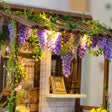 Detail of the wisteria pergola with warm string lights