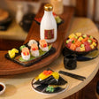 Detail of the sushi counter: salmon nigiri, chirashi bowl and sake bottle