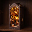 The Sorcerer's Archive book nook glowing on a dark walnut shelf at night