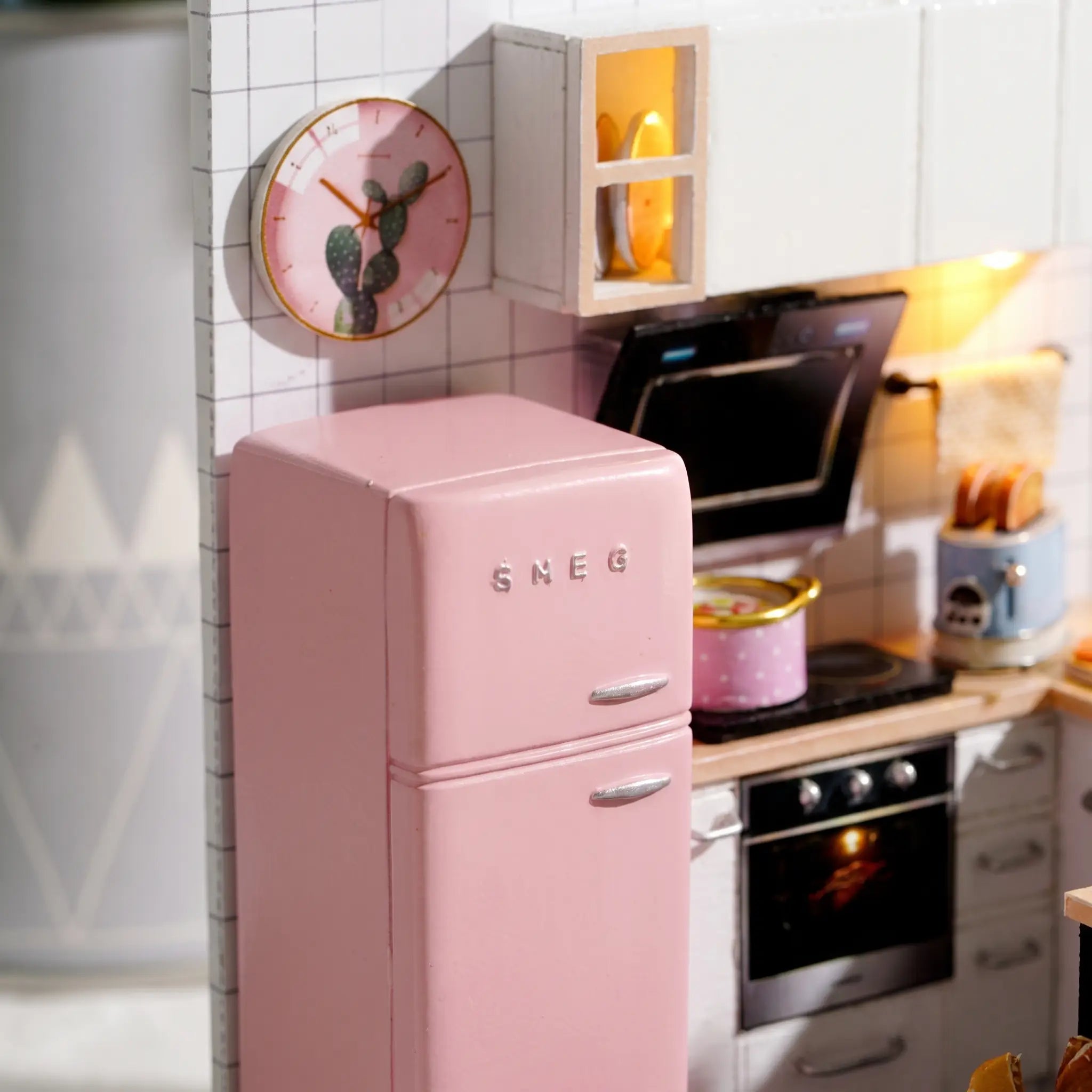 Macro detail of the pink retro fridge and lit cabinet inside The Breakfast Bar kit
