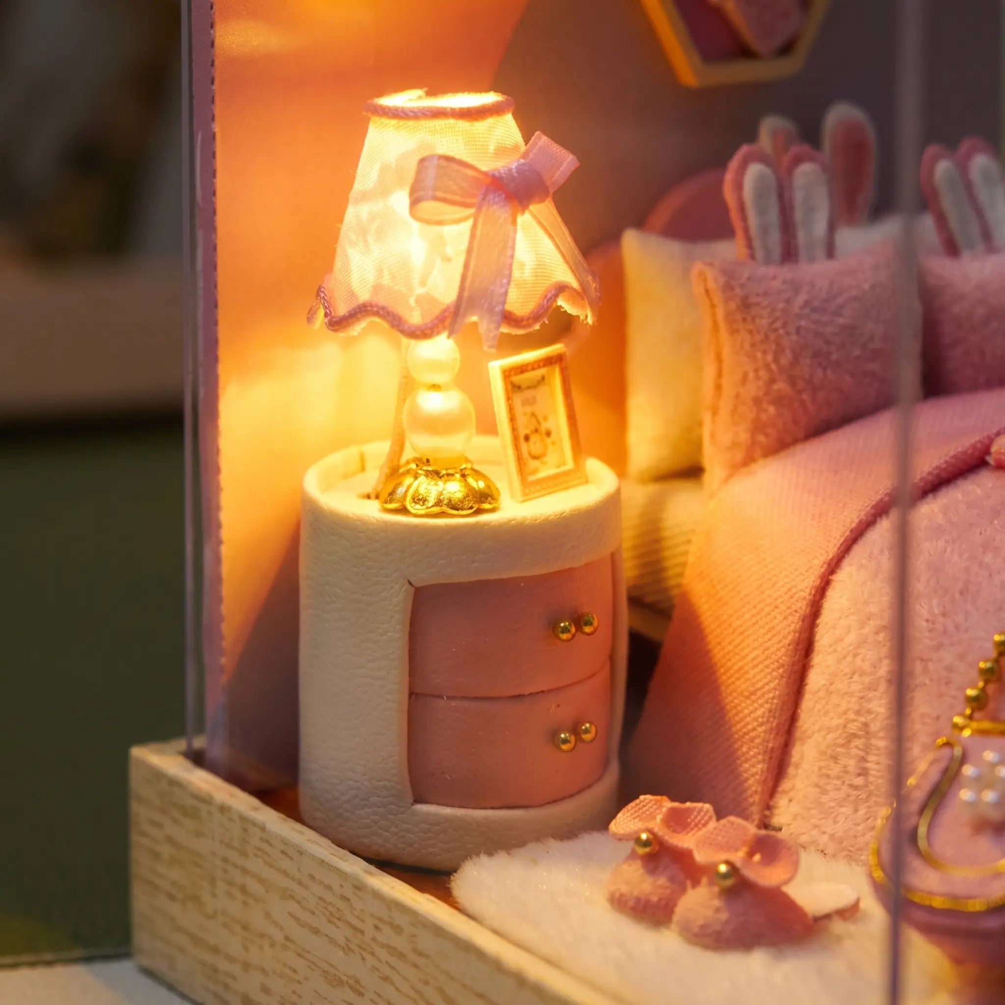 Macro detail of the glowing ruffled lamp and nightstand inside The Cottontail Room kit