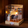 The Daydream Desk study corner roombox glowing on a dark walnut shelf at night