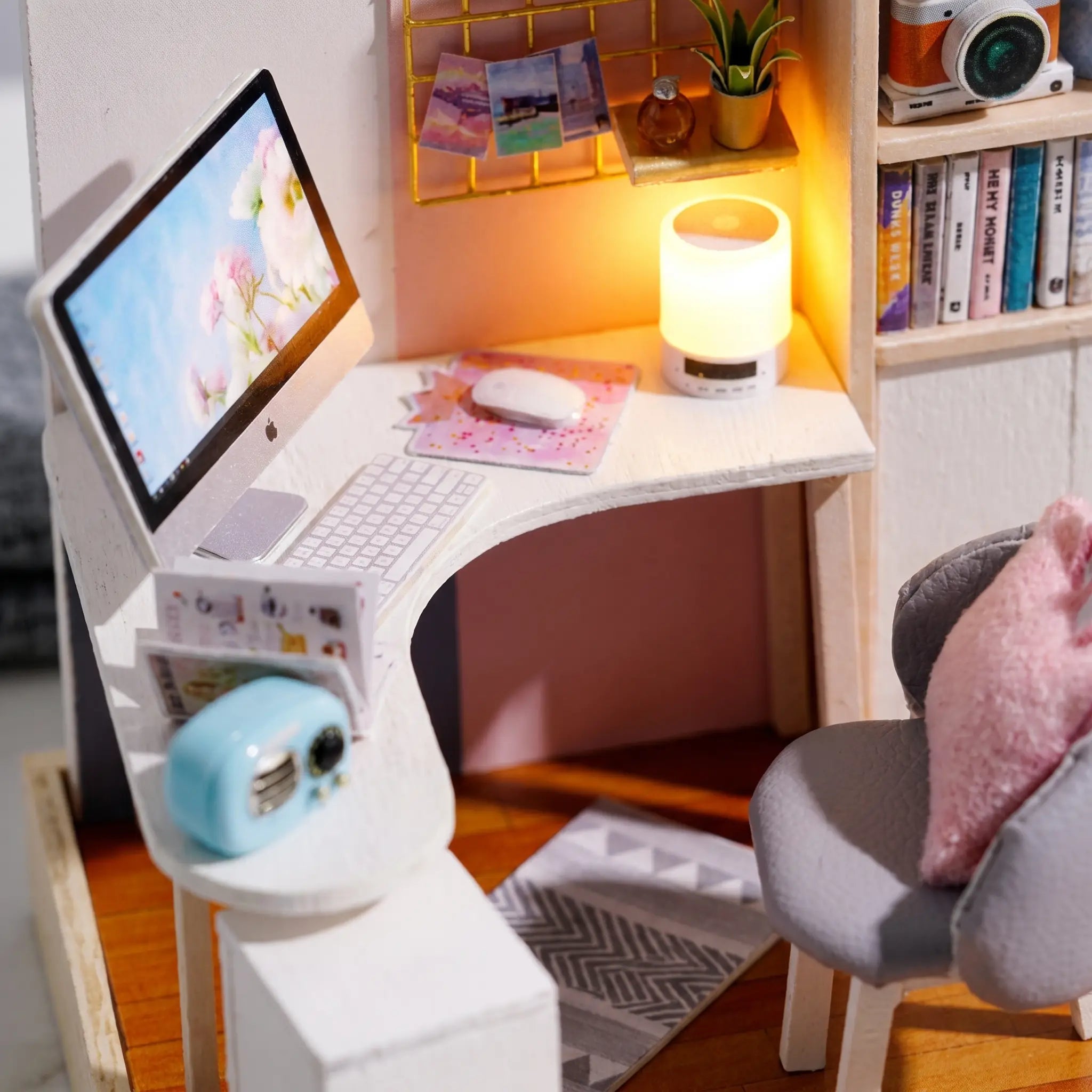 Macro detail of the corner desk with monitor, keyboard and glowing lamp inside The Daydream Desk kit