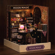 The Seer's Parlor roombox glowing on a dark walnut shelf at night