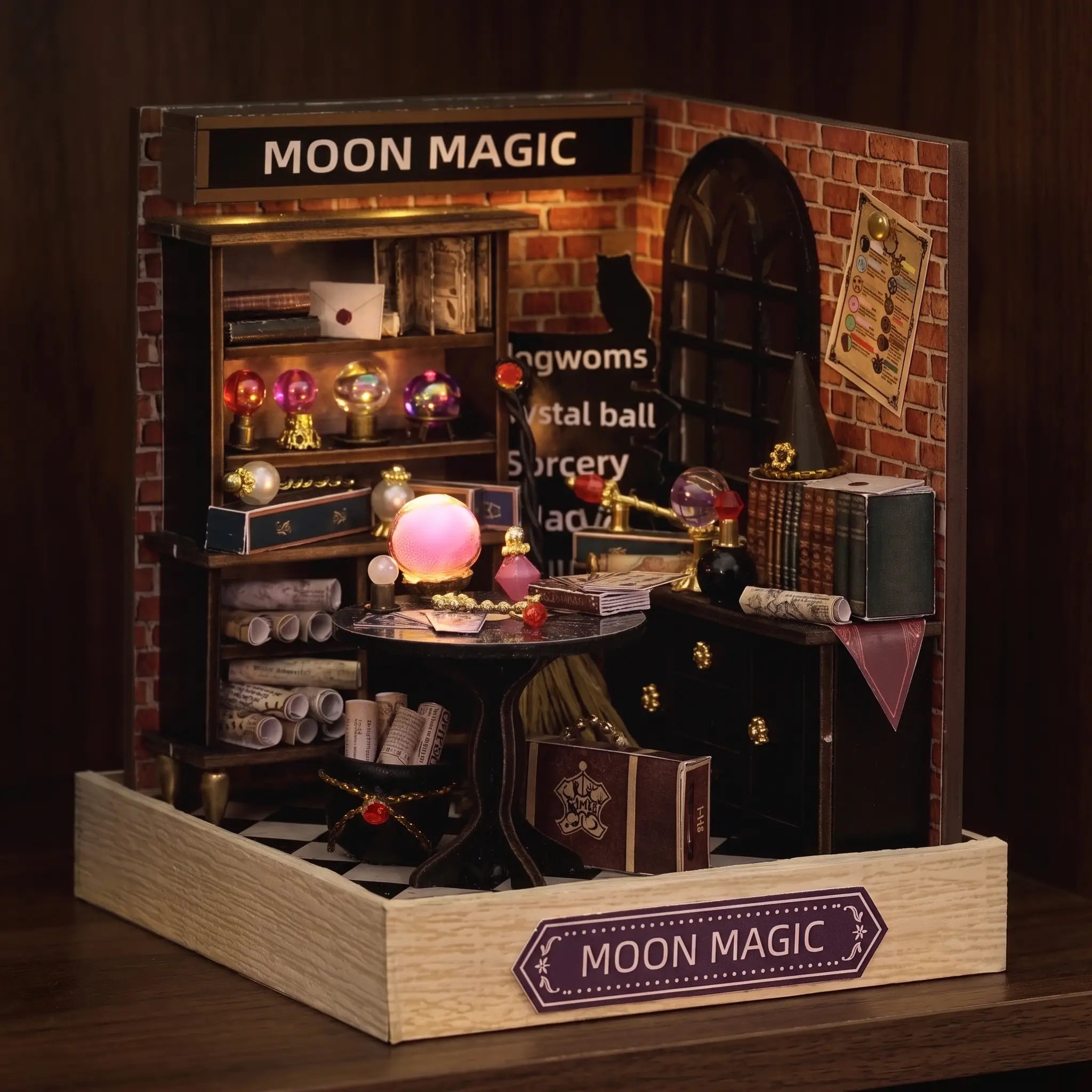 The Seer's Parlor roombox glowing on a dark walnut shelf at night