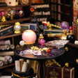 Macro detail of the glowing crystal ball and fanned tarot cards inside The Seer's Parlor kit
