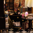 Macro detail of the cauldron of scrolls, broom and pointed hat inside The Seer's Parlor kit