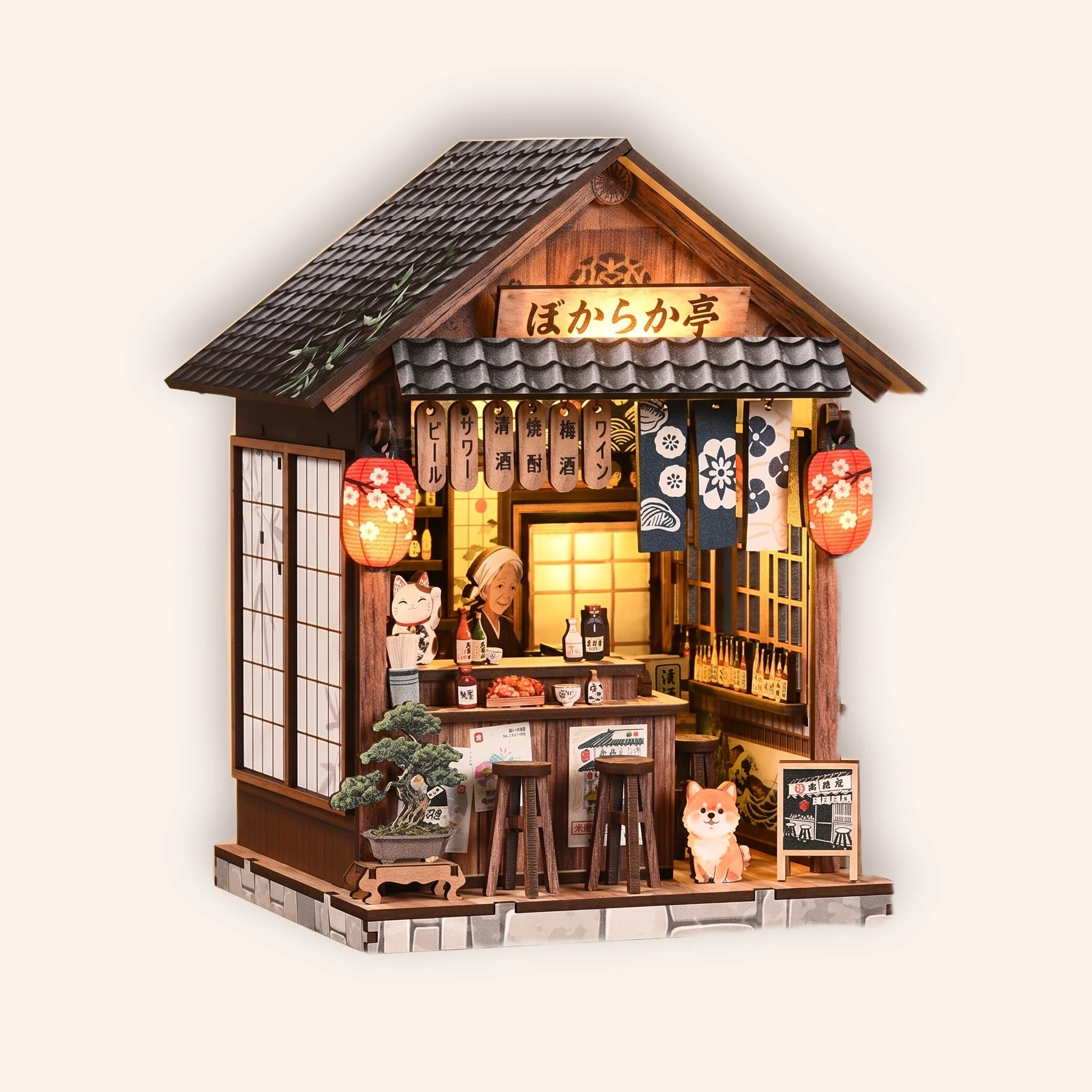 The Izakaya miniature Japanese pub kit on a cream background, red lanterns glowing