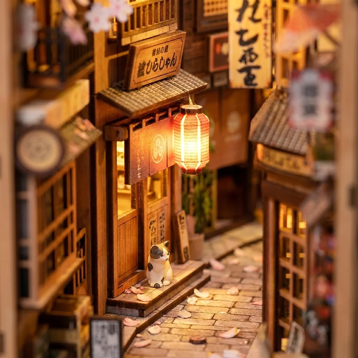 Close-up of the glowing lantern and cat in The Cat's Alley book nook
