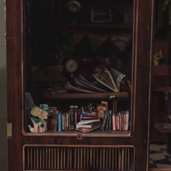 The Record Shop book nook showcase, warm interior lights glow to life over crates of vinyl and a gramophone