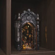 The Dragon's Keep book nook showcase, warm interior glowing to life