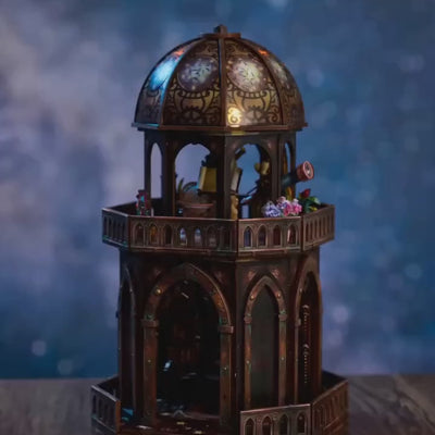 The Observatory tower showcase, warm LED lights glowing to life at dusk