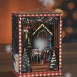 The Snow Cabin DIY book nook showcase, the cabin window glows warm as snow drifts