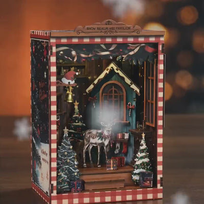 The Snow Cabin DIY book nook showcase, the cabin window glows warm as snow drifts