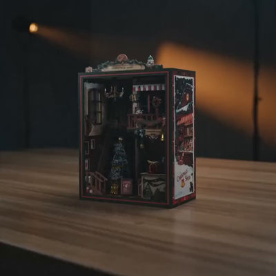 The Christmas Shop DIY book nook kit, lights glowing to life in a cinematic showcase